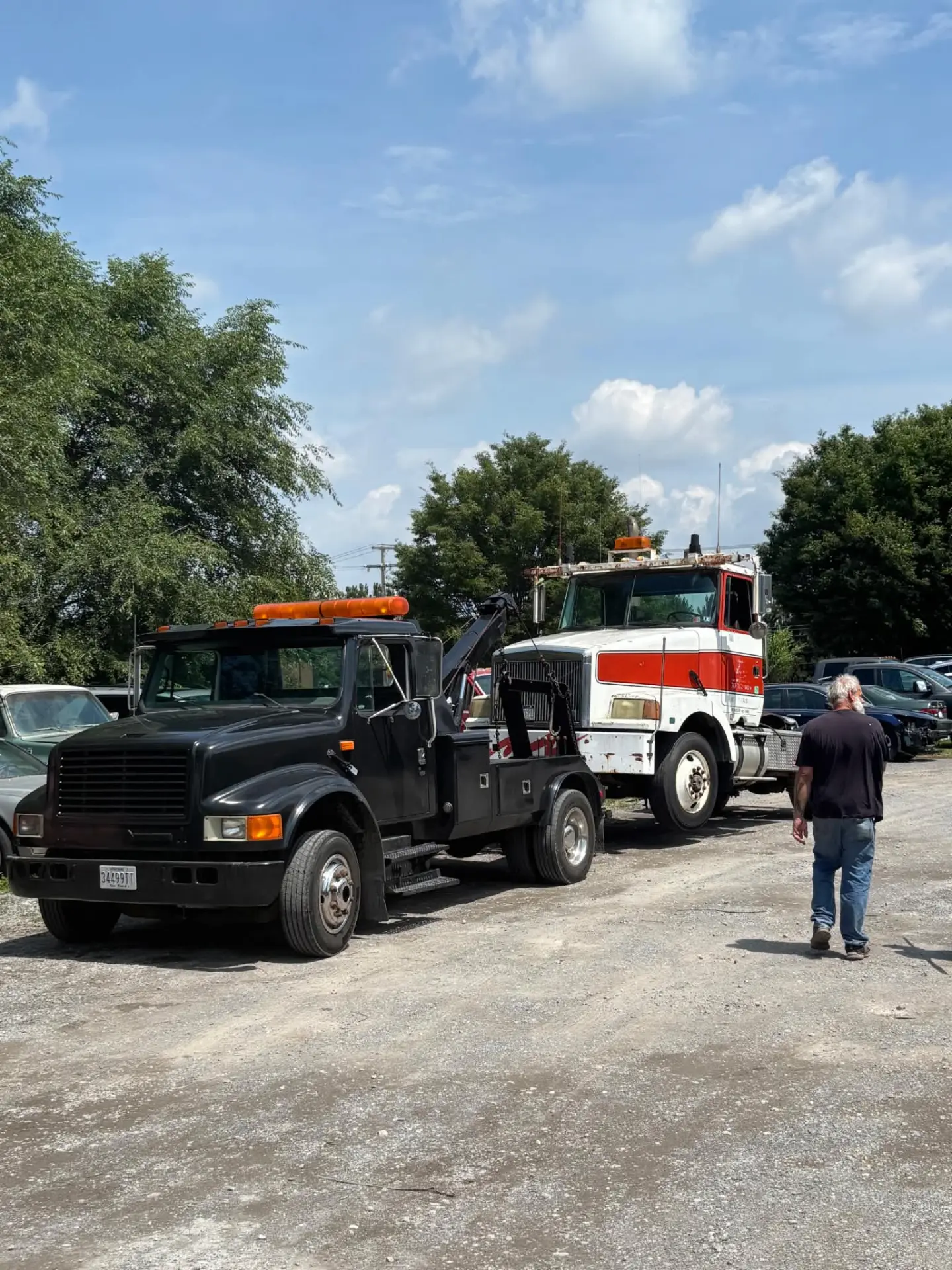 CARSTAR heavy duty tow truck recovering a commercial truck in a local lot